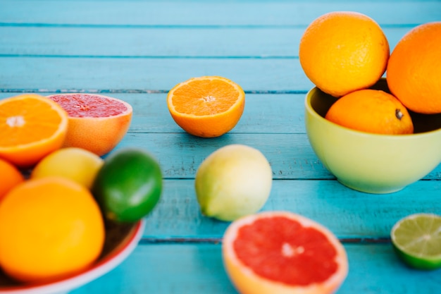 Close-up of various citrus fruits on wooden table top