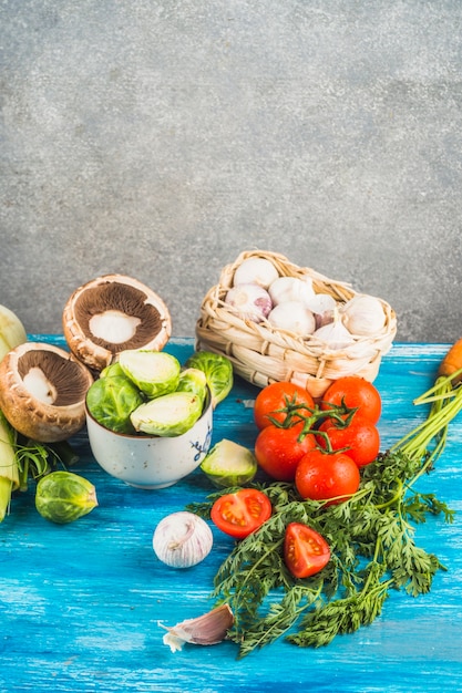 Free photo close-up of various fresh vegetables on blue wooden table