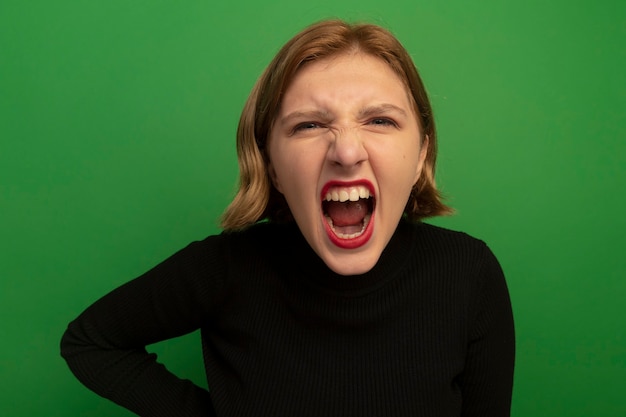 Close-up view of angry young blonde woman screaming