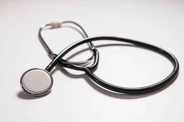 Close up view of black stethoscope on white back