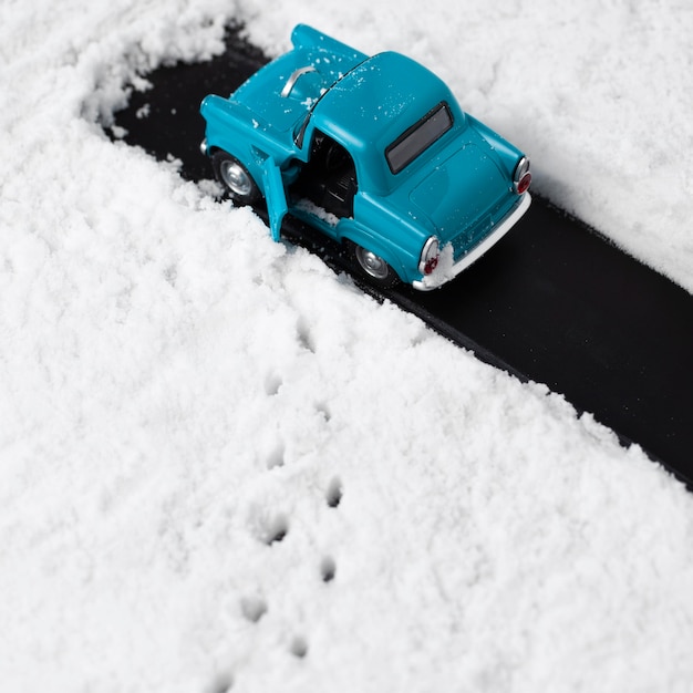 Close-up view of blue toy car with snow