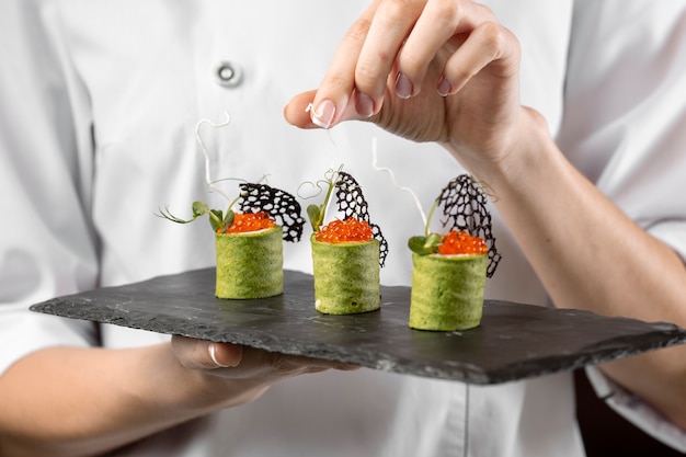 Close-up view of chef holding a food plate