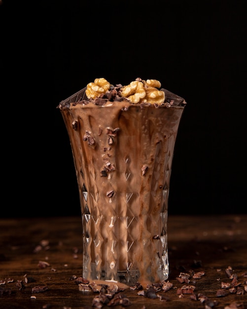 Free photo close-up view of chocolate milkshake with walnuts