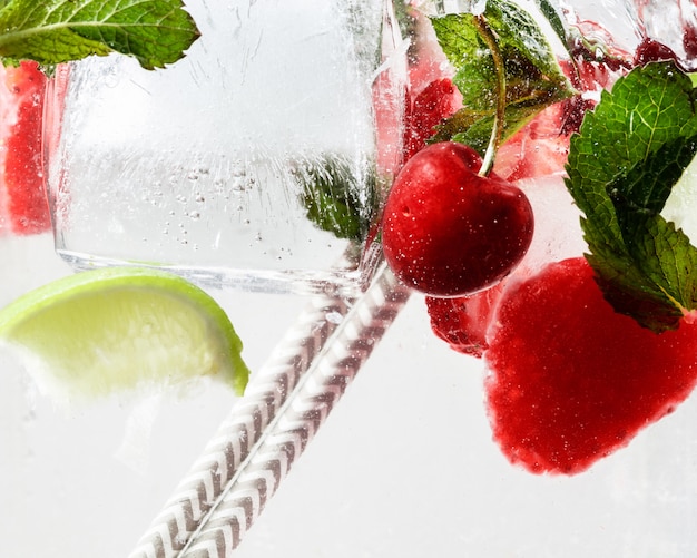 Free photo close up view of the cold and fresh lemonade with bright berries in neon light