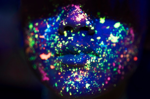 Free Photo close-up view of colorful fluorescent make-up on face