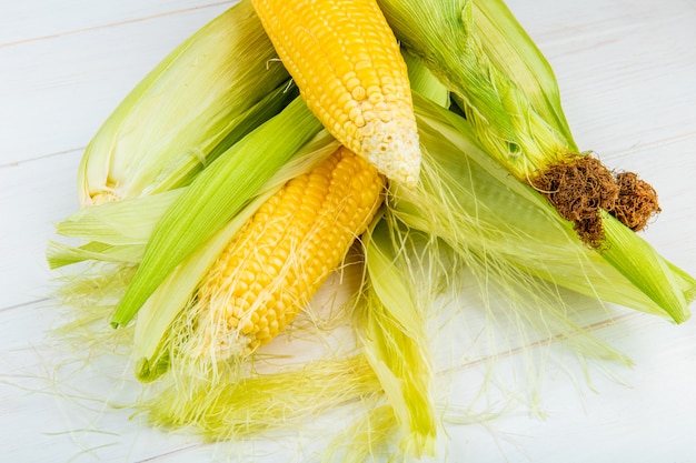 Close-up view of corn cobs on wooden table