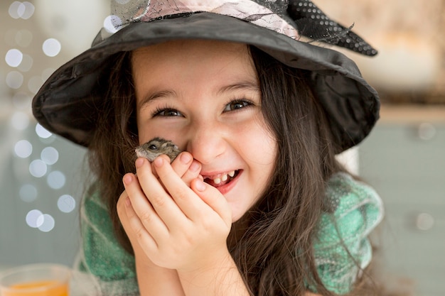 Close-up view of cute little girl holding a hamster