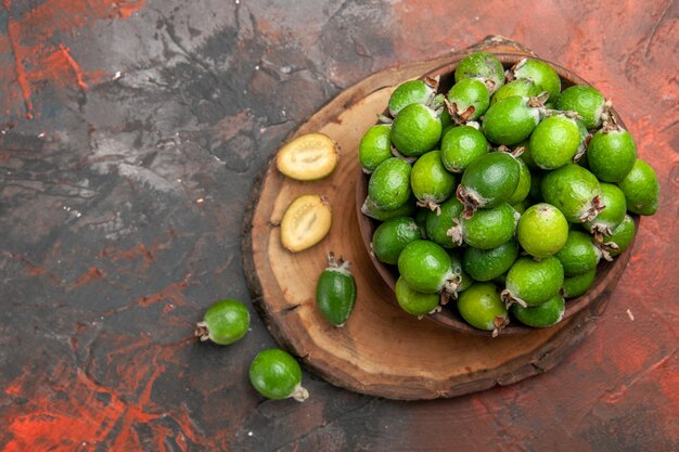 Close up view of green small vitamin bomb fresh feijoas in a brown pot