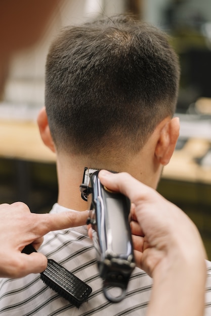 Close-up view of hairstilyst giving a haircut