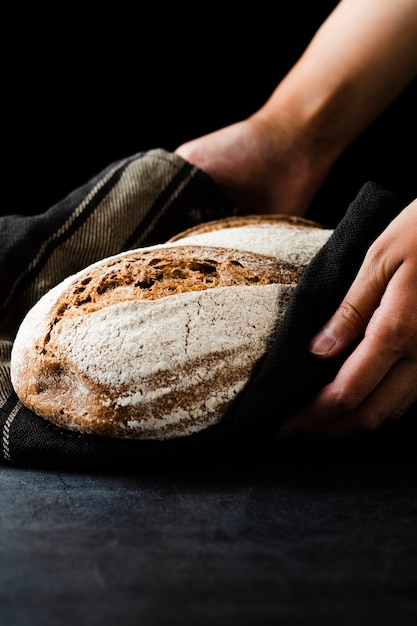 Free photo close-up view of hands holding bread