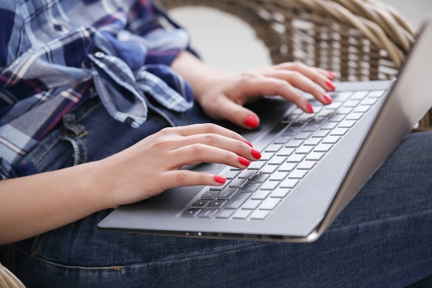 Close-up view of hands with manicure using computer