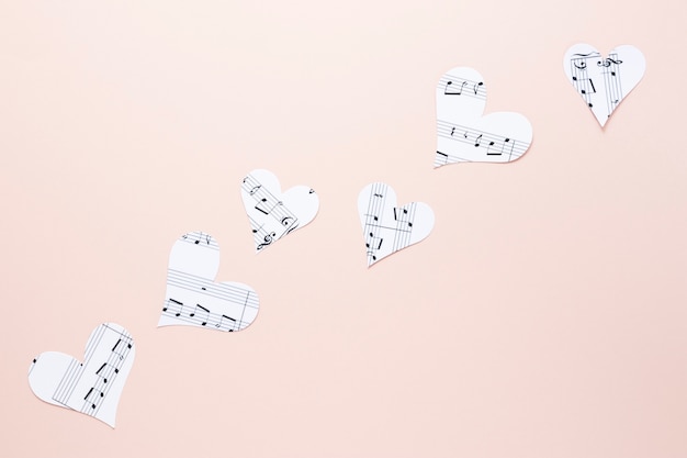 Free Photo close-up view of hearts with musical notes on plain background