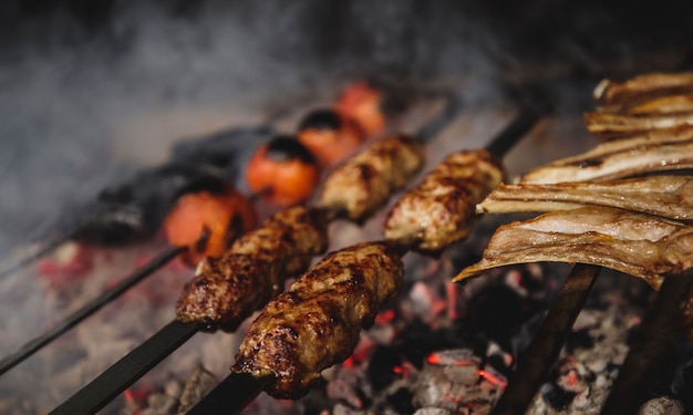 Free Photo close up view of lula kebab on metal skewers on dark wall