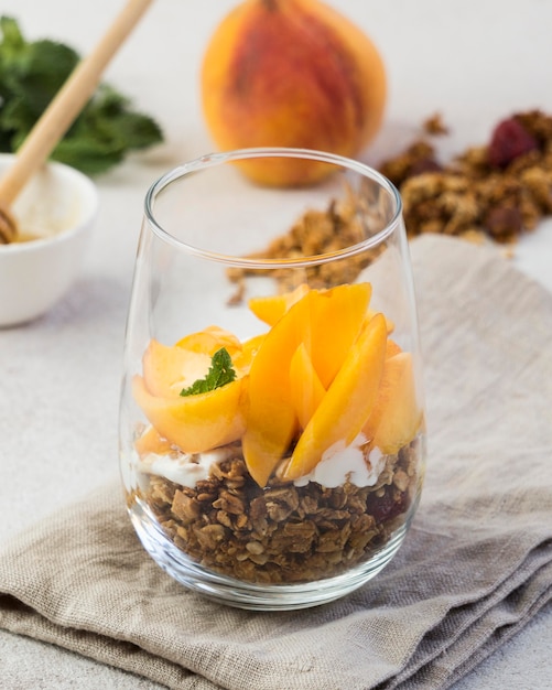 Free Photo close-up view of muesli with peaches in glass