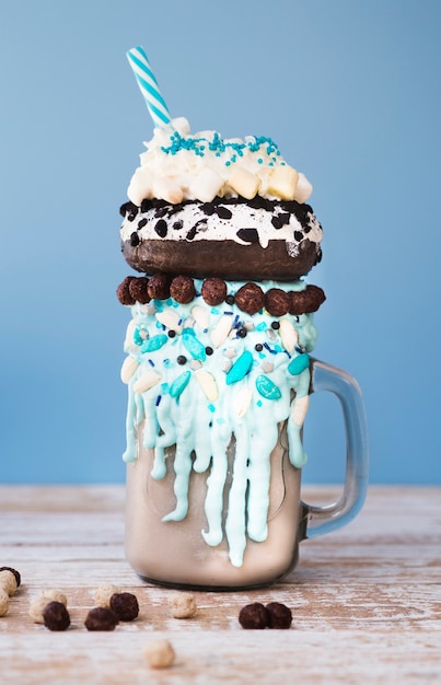 Close-up view of a mug of milkshake on wooden background