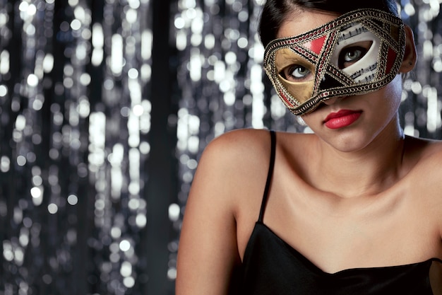 Close-up view of mysterious woman with carnival mask