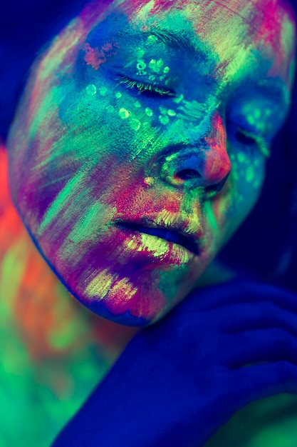 Free Photo close-up view of person with fluorescent make-up