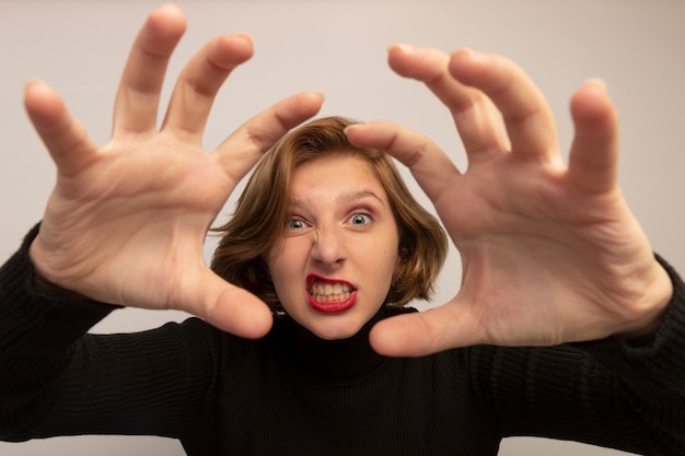 Free photo close-up view of playful young blonde girl doing tiger paws gesture