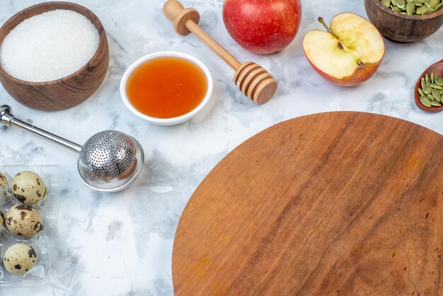 Close up view of round board and ingredients for the healthy food set on stained white background