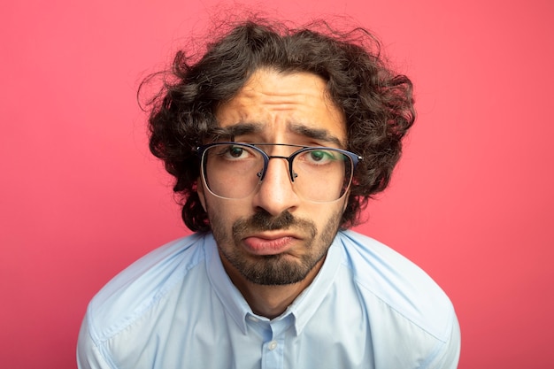 Free Photo close-up view of sad young handsome caucasian man wearing glasses  isolated on crimson wall