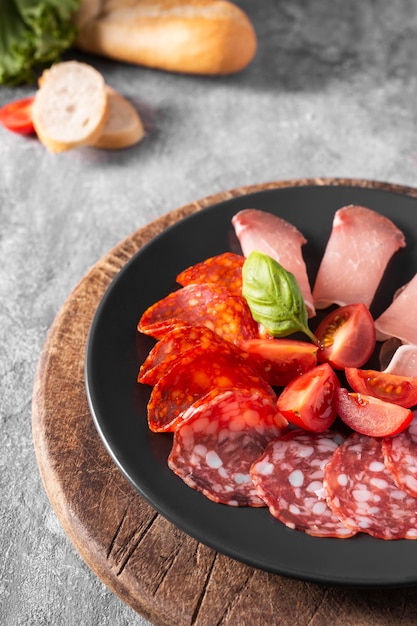 Free photo close-up view of salami an tomatoes on plate