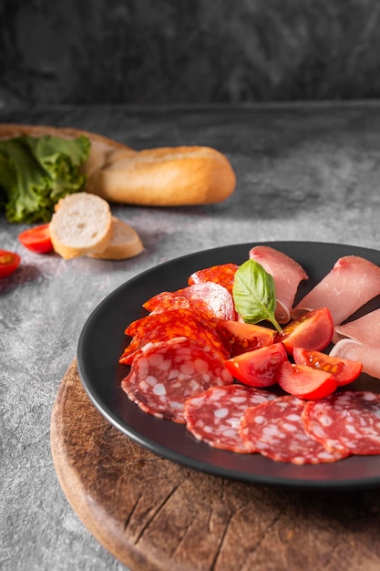 Close-up view of salami an tomatoes on plate