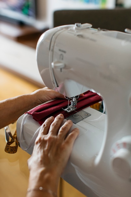 Close-up view of a senior person sewing cloth face masks