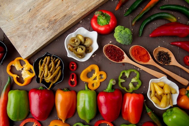 Close-up view of sliced, whole, salted peppers with spices, broccoli