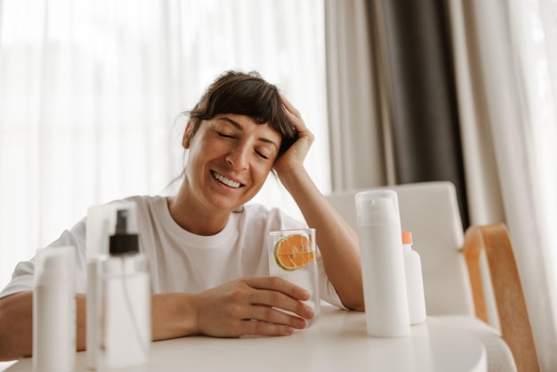 Free photo close up view of smiling woman with products