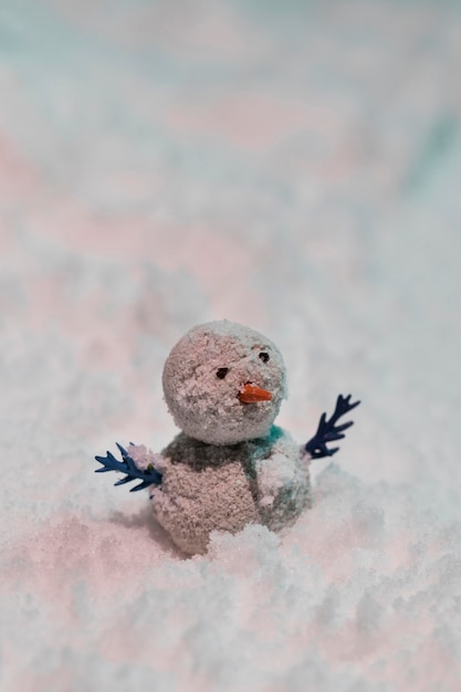 Free Photo close-up view of tiny snowman  on snow