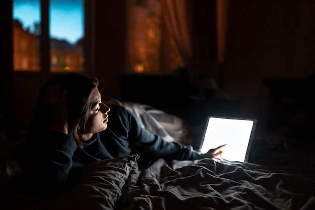 Close up to view woman's hands hold tablet with empty screen.