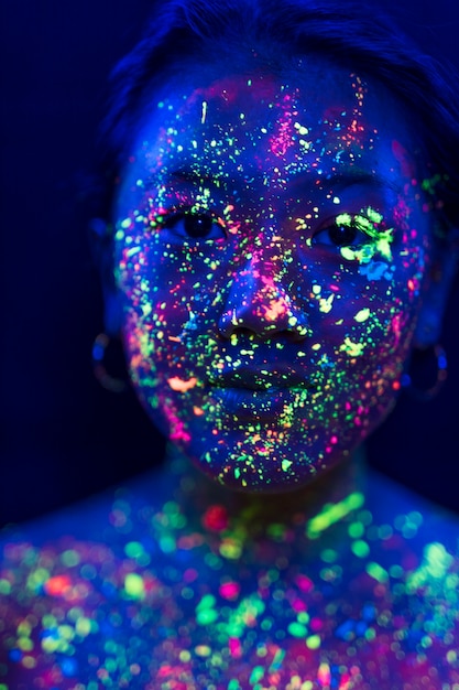 Free photo close-up view of woman with colorful fluorescent make-up