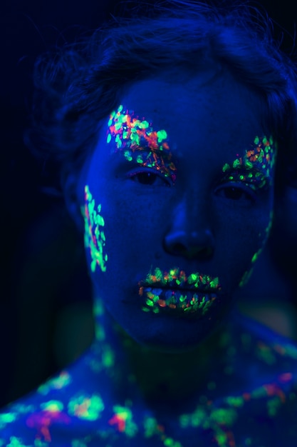 Free photo close-up view of woman with fluorescent make-up