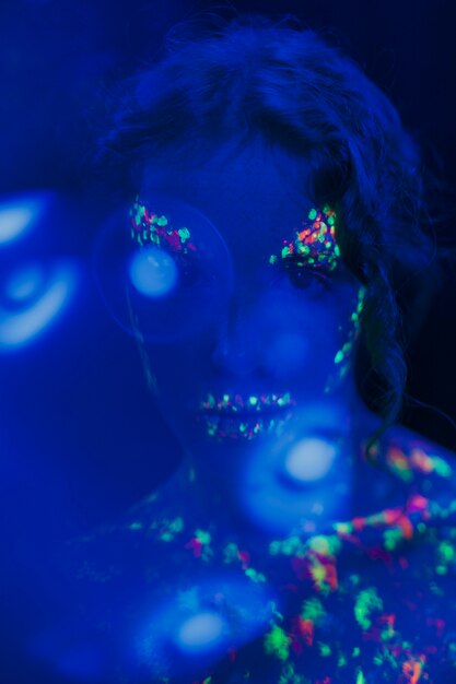 Close-up view of woman with fluorescent make-up