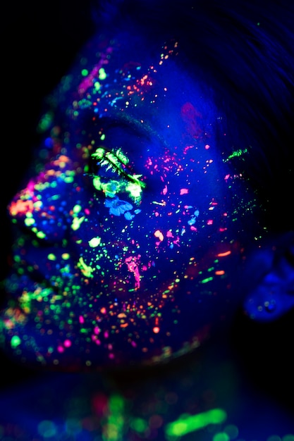 Free Photo close-up view of woman with fluorescent make-up