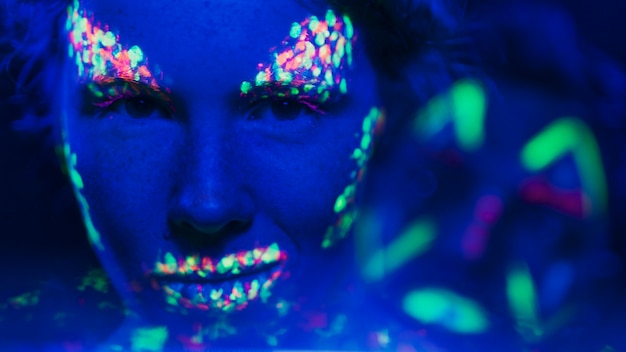 Free Photo close-up view of woman with fluorescent make-up