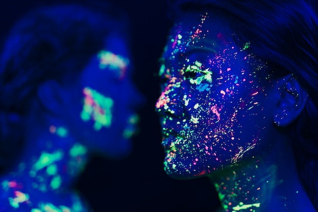 Close-up view of woman with fluorescent make-up