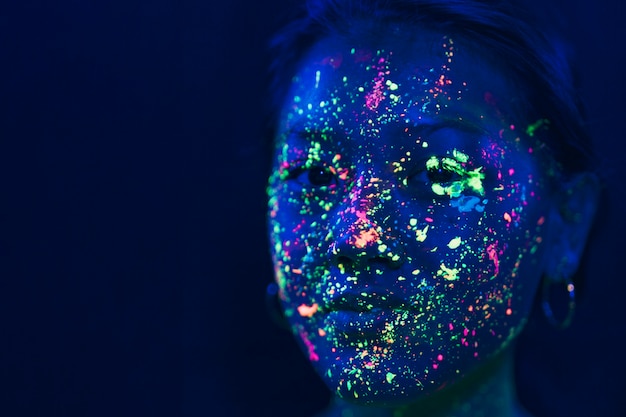 Free photo close-up view of woman with fluorescent make-up