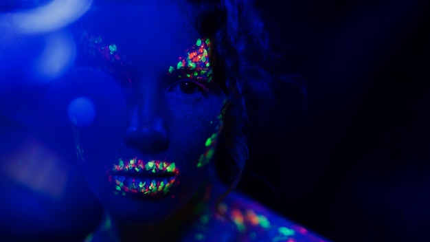 Close-up view of woman with fluorescent make-up