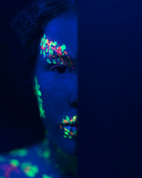 Close-up view of woman with fluorescent make-up