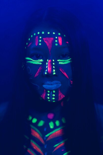 Close-up view of woman with fluorescent make-up