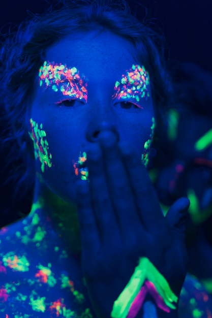 Close-up view of woman with her hand in front of face