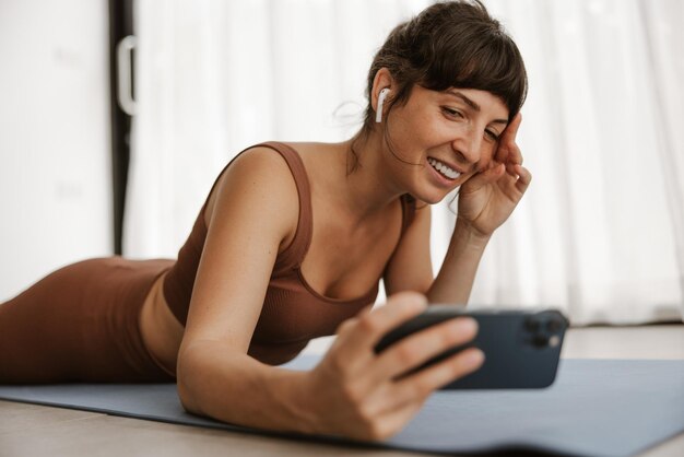 Close up view of women doing selfie on fitness mat at home