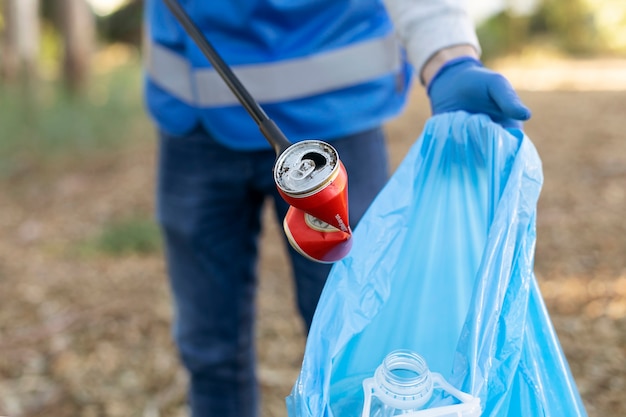 Free photo close up volunteer collecting garbage