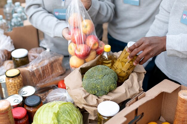 Close up volunteers collecting food donations