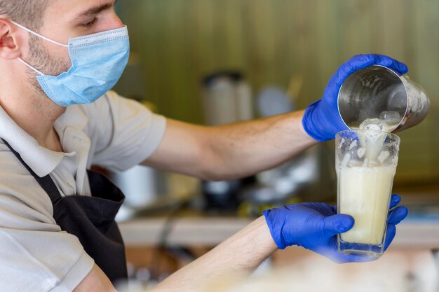 Free Photo close-up waiter with gloves and mask at work