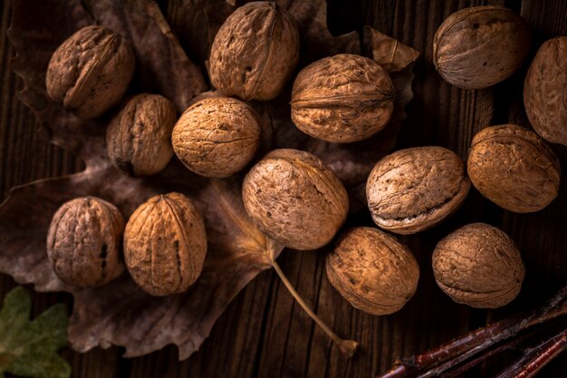 Close up walnuts on wooden table with leaves