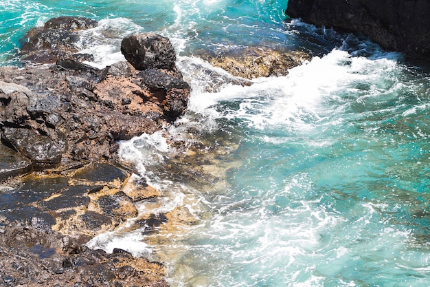 Free photo close-up  wavy water at rocky shore