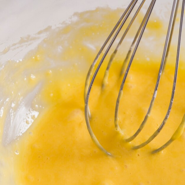 Close-up of whisk beating eggs