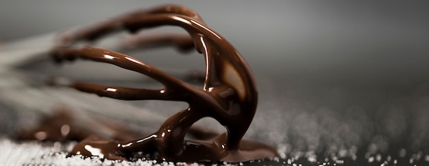 Free photo close-up whisk with melted chocolate and sugar